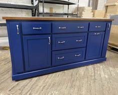 a kitchen island with blue cabinets and drawers