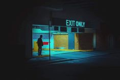 a man standing in front of an exit only store