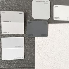 some white and gray paint samples are on the wall