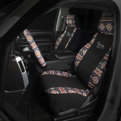 the interior of a car with black seats and colorful patterns on it's seat covers