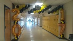 the hallway is decorated with balloons and streamers for new year's eve celebrations