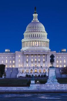 the capitol building lit up at night with lights on it's dome and fountain