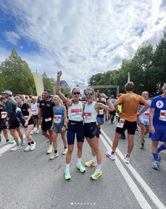 some people are standing in the street with their arms up