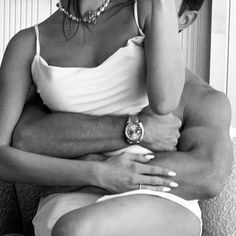 black and white photograph of a woman sitting on a couch talking on her cell phone