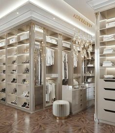 a walk in closet filled with lots of white shoes and clothes hanging from the ceiling