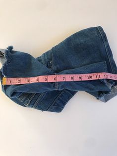 "Waist:26\" Rise:10.5\" Hips:32\" Inseam:6\" These are USA made Movin' On Levis zip fly cutoffs circa the late 70's or early 80's. They're tagged a vintage 28\" but fit a modern 26\" at largest. Please follow the measurements provided above and in the photos for an accurate fit as true vintage runs small and narrow. They're cut to the perfect unisex length and have amazing details on the pockets and feature a rare blue tab. 🍑(5)" Fitted Denim Blue Jean Shorts With Frayed Hem, Stretch Denim Distressed Jean Shorts, Fitted Denim Blue Cutoff Jean Shorts, Stretch Denim Jean Shorts With Frayed Hem, Vintage Jeans With Built-in Shorts For Spring, Distressed Stretch Jean Shorts In Medium Wash, Stretch Distressed Medium Wash Jean Shorts, Medium Wash Stretch Distressed Jean Shorts, Distressed Stretch Jean Shorts For Spring