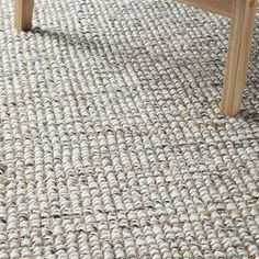 a wooden bench sitting on top of a carpeted floor next to a coffee table