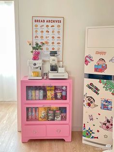 there is a pink dresser next to a refrigerator