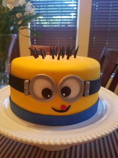 a yellow and blue cake with eyes on it