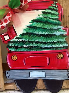 a red car with a christmas tree painted on it