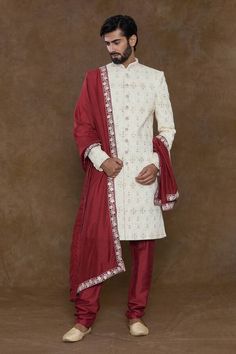 Off-white sherwani featuring sequin and bead hand work in geometric pattern. Paired with a red churidar and an embellished hem dupatta. - Aza Fashions Designer Red Sherwani With Traditional Drape, Designer Red Sherwani With Dupatta, White Fitted Churidar For Ceremonial Occasions, Festive White Bandhgala With Dupatta, Red Sherwani With Dabka Work For Festive Occasions, Festive Red Sherwani With Dabka Work, Festive White Sherwani With Dupatta, Red Sherwani With Dabka Work In Traditional Drape, Red Sherwani With Dabka Work