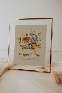 a photo frame sitting on top of a table next to a stuffed animal and other items