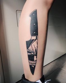 a tattoo on the leg of a person with a knife in it's center