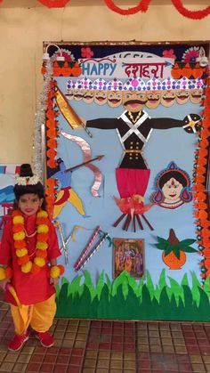 a young boy standing in front of a decorated door for diwaling the festival