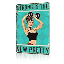 a sign that says strong is the new pretty with a woman lifting a dumbbell