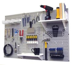 a pegboard with various tools hanging on it