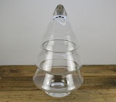 a clear glass vase sitting on top of a wooden table