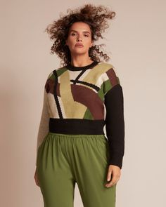 This retro-inspired sweater top features a geometric print complimented by a solid ribbed collar and cuffs. Pair it back to the Justina skirt for a print-on-print moment. This plus-size sweater top also pairs well with the Denise trouser. 11 Honoré Collection Alexis Sweater | Light Green / Brown | Tops | Materials & Care Instructions: ['80% Polyester, 20% Wool', 'Machine wash'] Chic Jacquard Knit Crew Neck Sweater, Patterned Sweater With Graphic Print For Fall, Retro Knit Tops With Ribbed Cuffs, Plus Size Joggers, Geometric Sweater, Wide Leg Dress Pants, Plus Size Pants, Plus Size Sweaters, Pattern Sweater