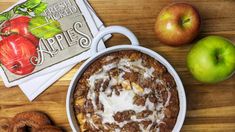 an apple pie and some apples on a table