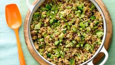 a pot filled with rice and broccoli on top of a table