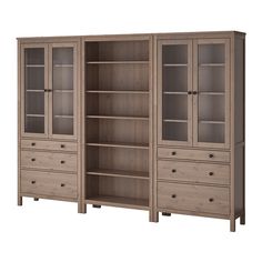 a large bookcase with drawers and glass doors on the front, side by side