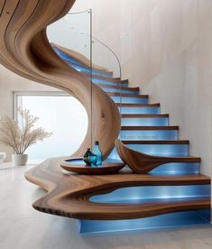 a wooden staircase with blue glass treads in a modern style house by the sea