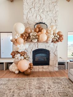 a living room with a fireplace and balloons on the mantle