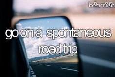 a car's rear view mirror with the words go on a spoonaneous road trip