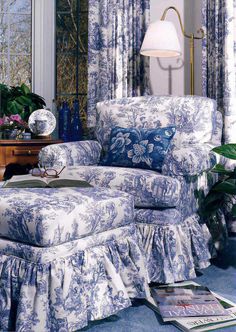 a blue and white chair sitting in front of a mirror