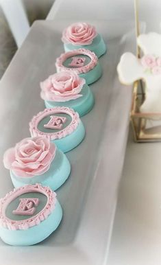 a row of blue and pink decorated cakes