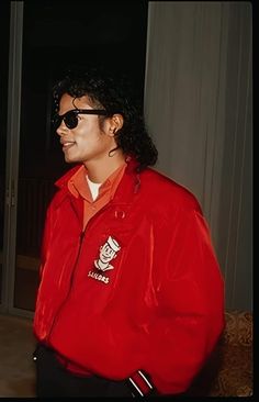 a man wearing sunglasses and a red jacket