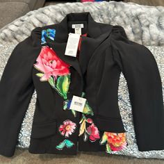 Moschino Blazer Jacket, Stunning, Peace, Brand New With The Tags Size 38, Which In Usa This Would Fit An X Small Or A Small Gorgeous Details With Beautiful Flowers Making These Piece Pretty Unique On The Blazer. It’s All Black With White Fine Lines. Brand New With The Tags The Inside Is A Burgundy And Satin Material. Multicolor Formal Outerwear For Spring, Multicolor Formal Spring Outerwear, Designer Fitted Blazer For Spring, Spring Formal Multicolor Outerwear, Designer Floral Print Outerwear For Work, Designer Floral Print Workwear Outerwear, Elegant Black Blazer With Floral Print, Fitted Floral Print Winter Blazer, Fitted Floral Print Blazer For Winter