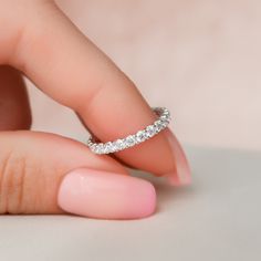 a woman's hand with a diamond ring on her finger