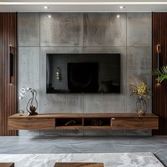 a modern living room with concrete walls and wooden furniture, including a large flat screen tv