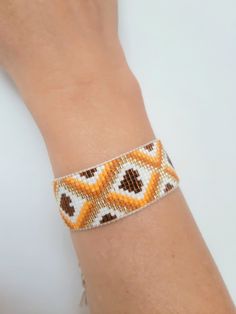 a woman's arm with a beaded bracelet on it