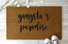 a door mat that says gangsta's paradise on it next to shoes