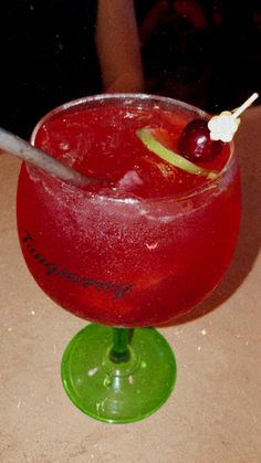 a red drink sitting on top of a table