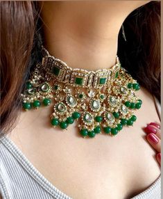 Adorn yourself in timeless elegance with this exquisite emerald green Kundan necklace set, perfect for weddings and special occasions. Crafted with meticulous attention to detail, the set features vibrant hot pink  hues reminiscent of Pakistani and Punjabi traditions, with a touch of Bollywood glamour. Complete with matching earrings and a stunning maangtika, this Indian Kundan ensemble effortlessly captures the essence of sophistication and grace. Measurements:  Weight- 140 gms  Necklace Length Green Kundan Choker For Wedding, Emerald Kundan Necklace For Wedding And Festivals, Bollywood Style Emerald Kundan Necklace For Wedding, Green Kundan Necklace For Eid Wedding, Emerald Meenakari Kundan Necklace For Wedding, Heavy Green Kundan Necklace For Eid, Heavy Emerald Kundan Necklace For Wedding, Green Bollywood Choker For Wedding, Heavy Green Jewelry For Eid