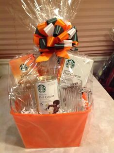 a starbucks gift basket with coffee mugs, tea cups and candy bar wrappers