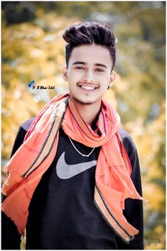 a young man wearing an orange scarf and black shirt