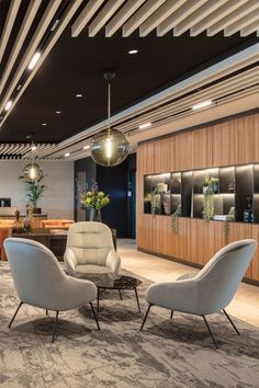 an office lobby with modern chairs and tables