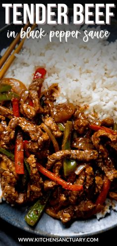 a plate with rice, meat and peppers next to chopsticks on the side