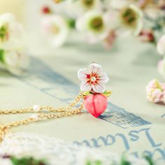 Infuse sweetness into your style with our Peach Floral Necklace! The gentle pink hues and delicate floral design embody the beauty of nature's bounty. Like the succulent flesh of a ripe peach, this necklace radiates warmth and charm. A delightful accessory to complement your attire and bring a touch of nature's sweetness to your look. 🍑🌸 DETAILS Plating: 18K Gold Materials: 18K Gold on Brass,  Enamel Measurements: Length:   16.54"(42cm)  + Extender: 3.15"(8cm) Pendant Size: 0.51"*0.67"(2.3cm Pink Pendant Necklace, Fruit Necklace, Blue Morpho Butterfly, Pearl Gifts, Unique Gift Wrapping, Nature's Bounty, Butterfly Gifts, Purple Grapes, Enamel Necklaces