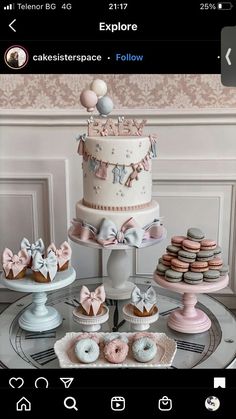 a table topped with lots of cakes and cupcakes