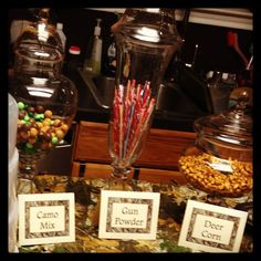 there are candy and candies in glass jars on the counter next to each other