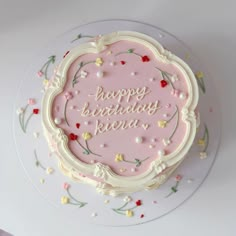 a pink birthday cake with the words happy birthday pera on it's frosting