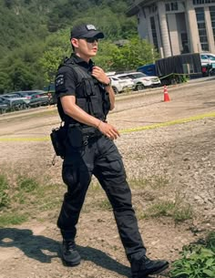 a police officer is walking in the dirt