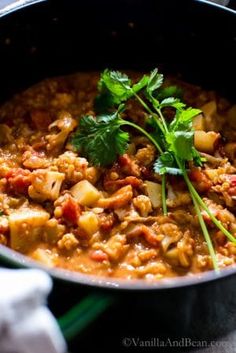 a pot filled with food sitting on top of a stove