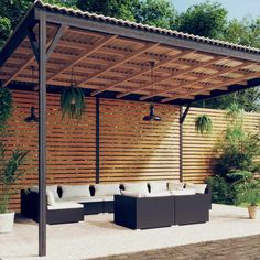 an outdoor seating area with wooden slatted walls and potted plants on the side