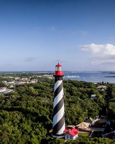 an aerial view of a lighthouse surrounded by trees